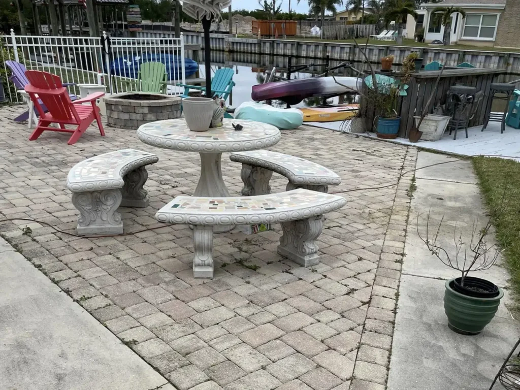 Pressure washing stained pavers on a patio in Melbourne, FL